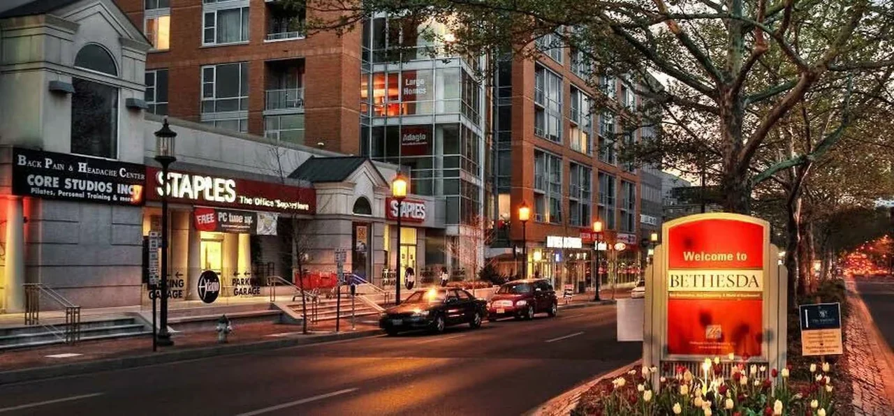 Downtown Bethesda storefronts beside a Welcome to Bethesda sign.